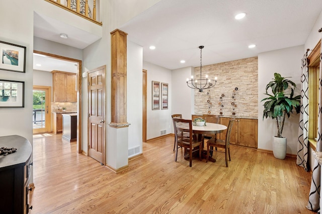 dining room featuring light wood finished floors, a chandelier, recessed lighting, and baseboards