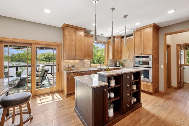 kitchen with double oven, open shelves, backsplash, a sink, and recessed lighting