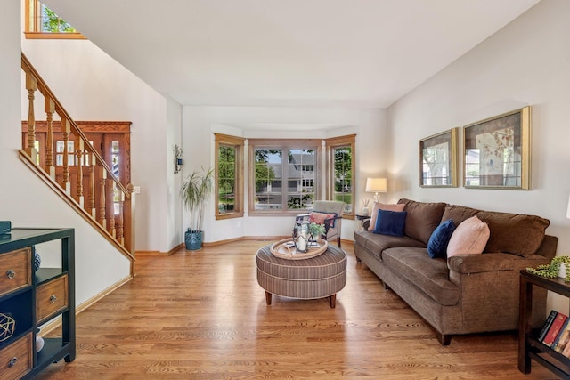 living area featuring stairway and wood finished floors