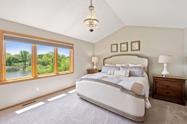 carpeted bedroom with vaulted ceiling, a chandelier, and baseboards
