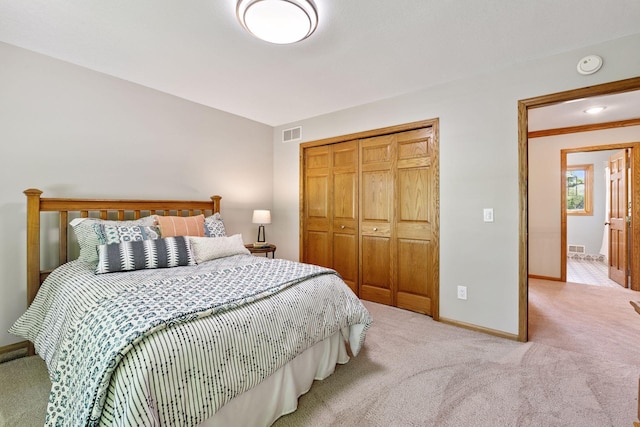 bedroom featuring carpet, baseboards, and a closet