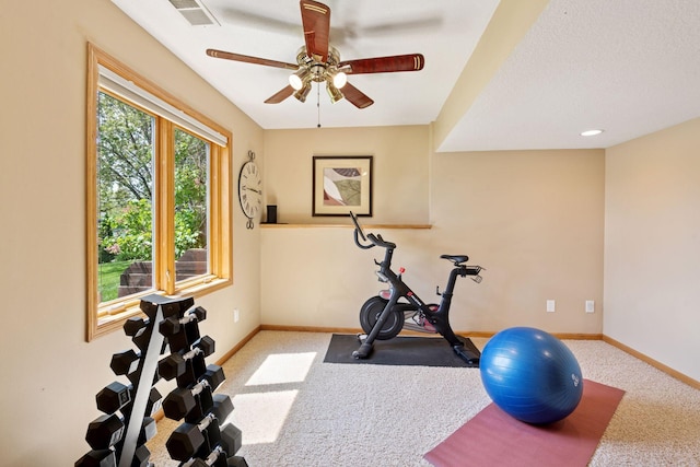 exercise room featuring carpet, baseboards, and ceiling fan