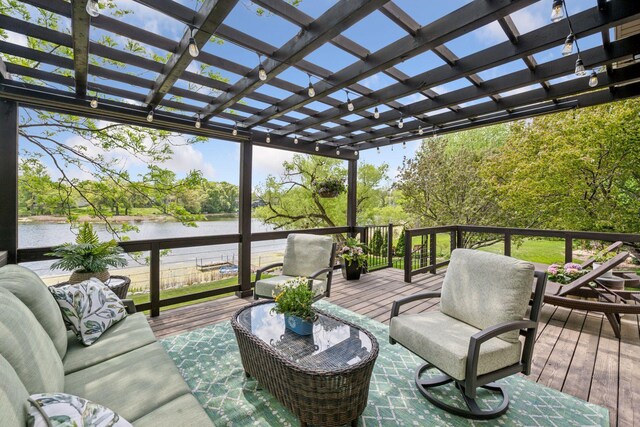 wooden terrace featuring an outdoor hangout area, a water view, a pergola, and view of scattered trees