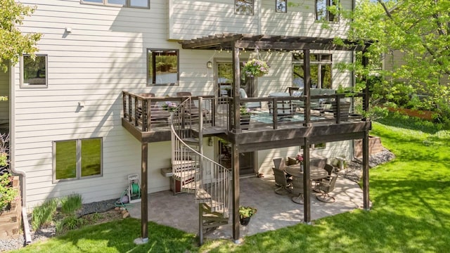 back of house featuring a pergola, a yard, a patio, and a wooden deck