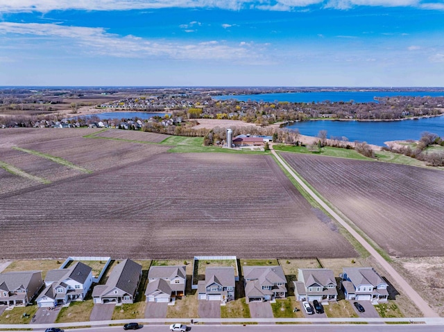 drone / aerial view featuring a residential view and a water view