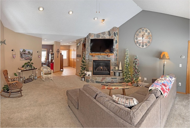 carpeted living area featuring lofted ceiling, baseboards, a stone fireplace, and recessed lighting