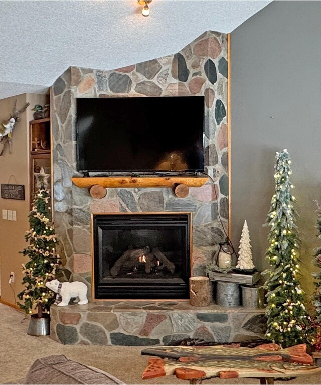 interior details with a fireplace, carpet, and a textured ceiling