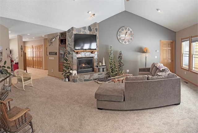 living room with vaulted ceiling, a stone fireplace, carpet floors, visible vents, and recessed lighting