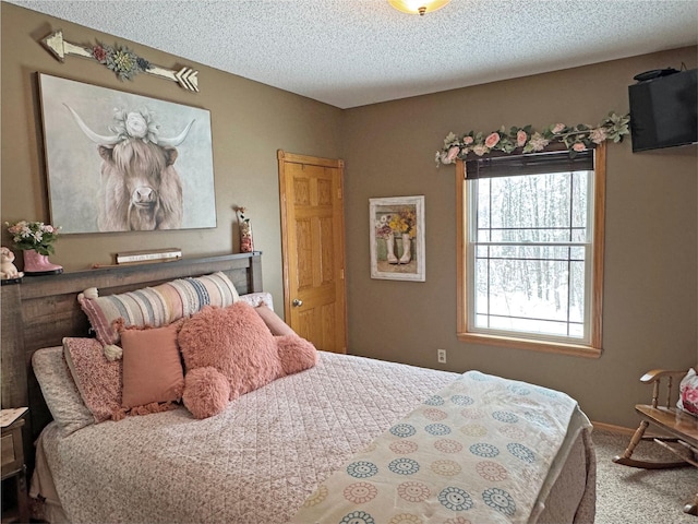 bedroom featuring carpet floors and a textured ceiling