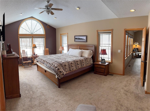 bedroom with a textured ceiling, baseboards, light colored carpet, lofted ceiling, and ceiling fan