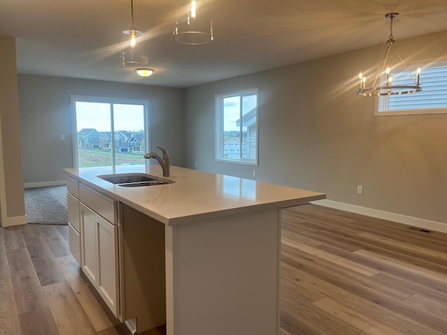1595 76th St W, Inver Grove Heights, MN 55077 - kitchen featuring a sink, light wood-type flooring, baseboards, and healthy amount of natural light