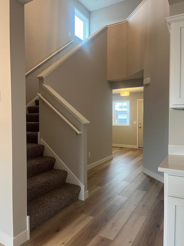1595 76th St W, Inver Grove Heights, MN 55077 - stairs featuring wood finished floors and baseboards