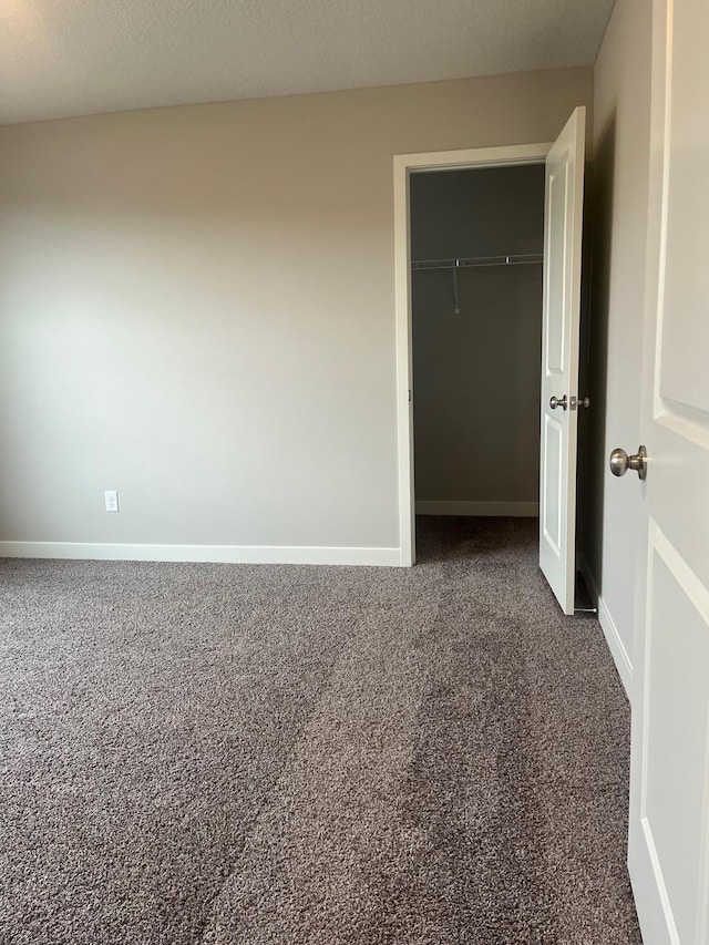 1595 76th St W, Inver Grove Heights, MN 55077 - unfurnished bedroom with dark colored carpet, baseboards, and a closet