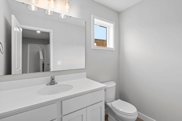 1595 76th St W, Inver Grove Heights, MN 55077 - bathroom with vanity, toilet, and baseboards