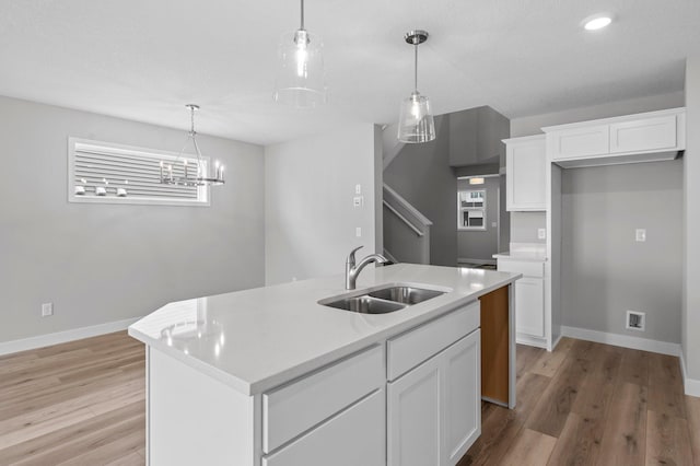 1595 76th St W, Inver Grove Heights, MN 55077 - kitchen with a sink, baseboards, white cabinets, light wood-type flooring, and recessed lighting