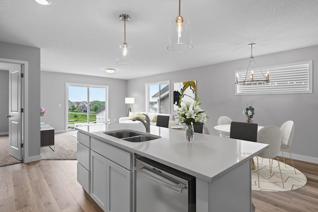 1595 76th St W, Inver Grove Heights, MN 55077 - kitchen with dishwasher, a sink, light wood finished floors, light countertops, and open floor plan