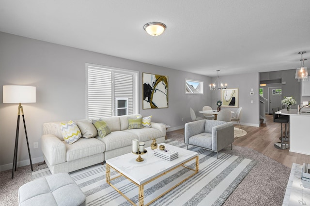 1595 76th St W, Inver Grove Heights, MN 55077 - living area featuring a chandelier, baseboards, and wood finished floors