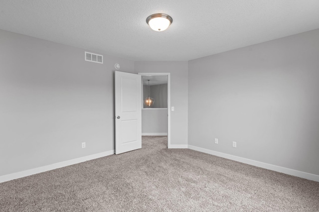 1595 76th St W, Inver Grove Heights, MN 55077 - carpeted spare room with baseboards and a textured ceiling