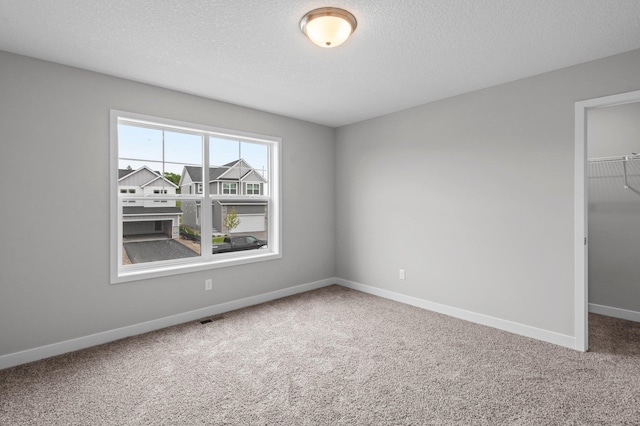 1595 76th St W, Inver Grove Heights, MN 55077 - unfurnished room featuring carpet flooring, baseboards, and a textured ceiling