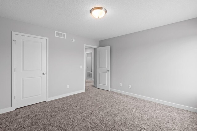 1595 76th St W, Inver Grove Heights, MN 55077 - unfurnished bedroom with carpet, baseboards, and a textured ceiling