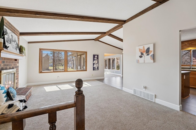living area featuring visible vents, baseboards, and carpet flooring