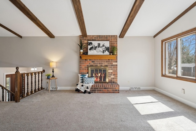unfurnished living room featuring carpet flooring, visible vents, vaulted ceiling with beams, and a brick fireplace