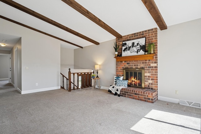 carpeted living room featuring baseboards, vaulted ceiling with beams, visible vents, and a brick fireplace