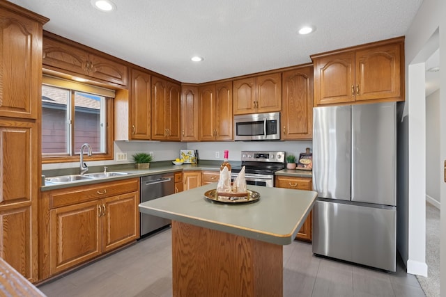 kitchen with stainless steel appliances, brown cabinetry, and a sink