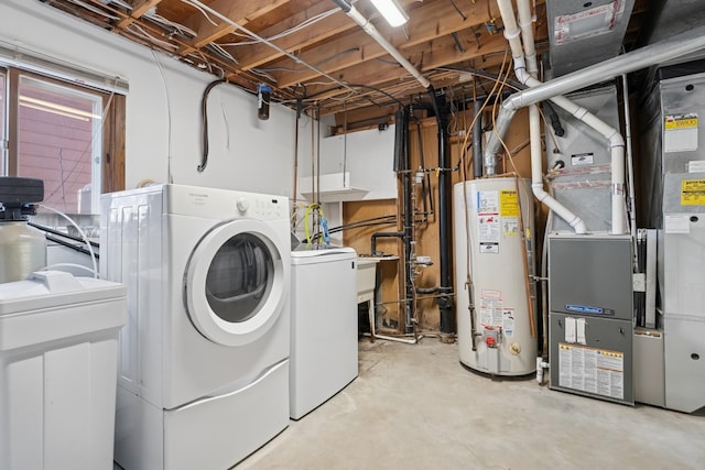 laundry area featuring washing machine and dryer, laundry area, heating unit, and gas water heater
