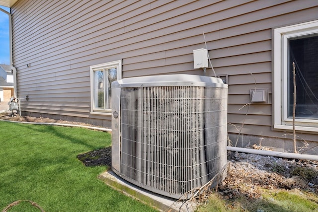 exterior details featuring gas meter and central AC unit