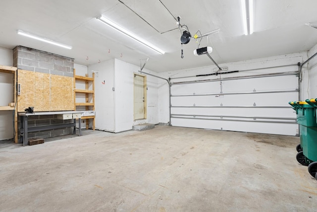 garage with a workshop area and a garage door opener