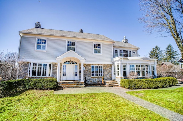 4927 Lake Ave, White Bear Lake, MN 55110 - view of front of property featuring a chimney, a front lawn, and stone siding