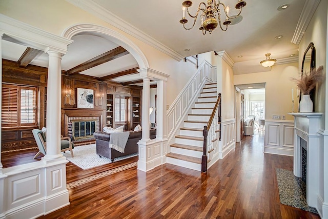 4927 Lake Ave, White Bear Lake, MN 55110 - living area featuring a fireplace with flush hearth, ornamental molding, ornate columns, and dark wood-type flooring