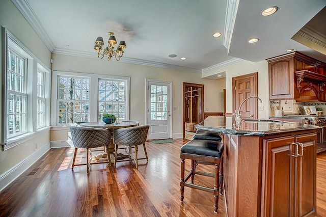 4927 Lake Ave, White Bear Lake, MN 55110 - kitchen with a sink, a notable chandelier, a wealth of natural light, and a kitchen bar
