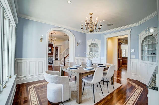 4927 Lake Ave, White Bear Lake, MN 55110 - dining space featuring crown molding, wainscoting, a decorative wall, a chandelier, and arched walkways