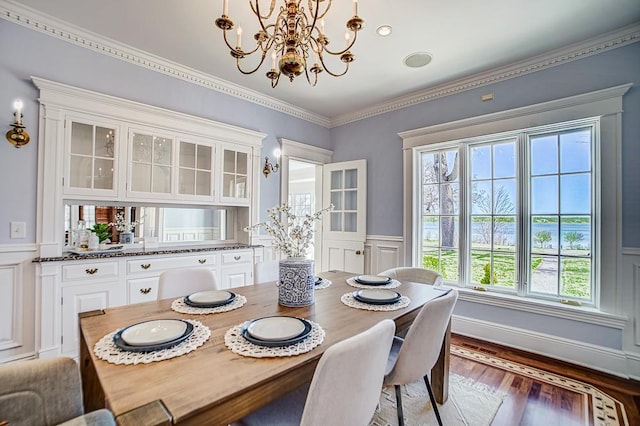 4927 Lake Ave, White Bear Lake, MN 55110 - dining room featuring a healthy amount of sunlight, wainscoting, wood finished floors, and a notable chandelier