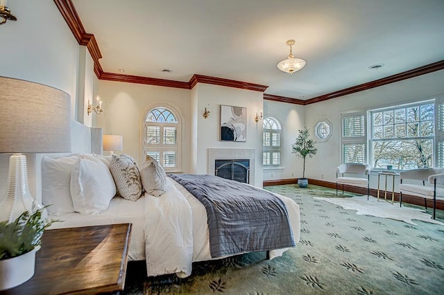 4927 Lake Ave, White Bear Lake, MN 55110 - bedroom with crown molding, baseboards, multiple windows, and a glass covered fireplace
