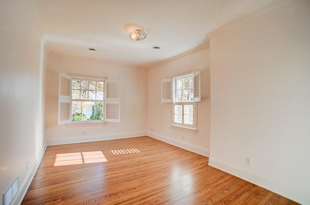 4927 Lake Ave, White Bear Lake, MN 55110 - spare room with crown molding, baseboards, visible vents, and wood finished floors