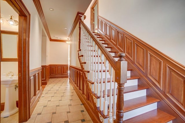 4927 Lake Ave, White Bear Lake, MN 55110 - staircase with crown molding, a decorative wall, wainscoting, and recessed lighting