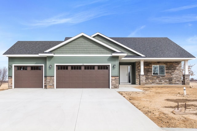 136 Mercy Dr, Faribault, MN 55021 - craftsman-style house featuring stone siding, driveway, a garage, and a shingled roof