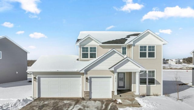 view of front of home with aphalt driveway and an attached garage