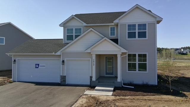 view of front of house with an attached garage and aphalt driveway