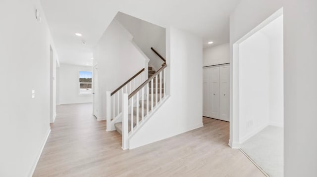 stairs with recessed lighting, wood finished floors, and baseboards