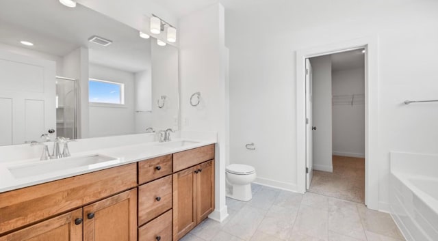 bathroom with visible vents, a shower with shower door, double vanity, and a sink