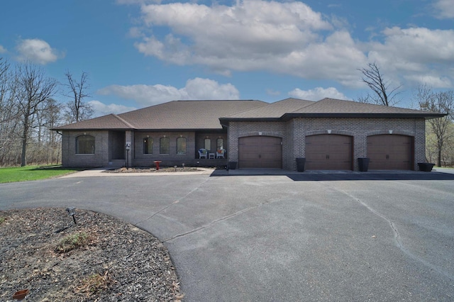 6203 Fairfax Ct, Baxter, MN 56425 - view of front of house with brick siding, asphalt driveway, and a garage