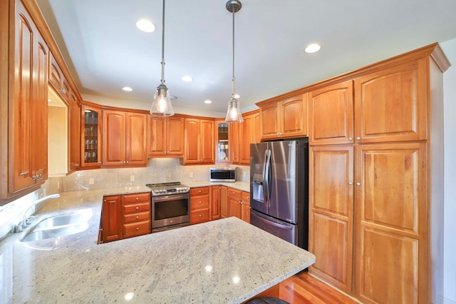 6203 Fairfax Ct, Baxter, MN 56425 - kitchen with appliances with stainless steel finishes, a sink, glass insert cabinets, a peninsula, and light stone counters