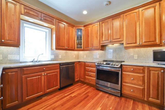 6203 Fairfax Ct, Baxter, MN 56425 - kitchen with appliances with stainless steel finishes, a sink, light wood-type flooring, light stone countertops, and brown cabinetry