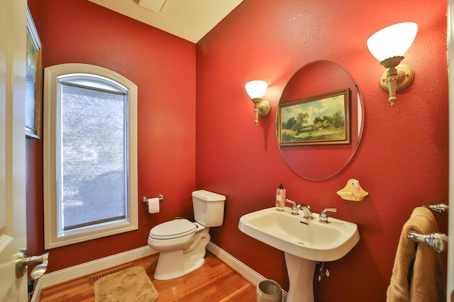 6203 Fairfax Ct, Baxter, MN 56425 - half bathroom featuring toilet, wood finished floors, and baseboards