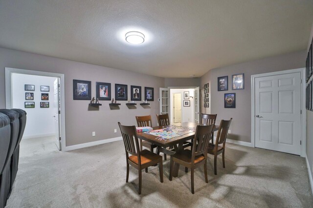 6203 Fairfax Ct, Baxter, MN 56425 - dining room featuring light colored carpet, baseboards, and a textured ceiling