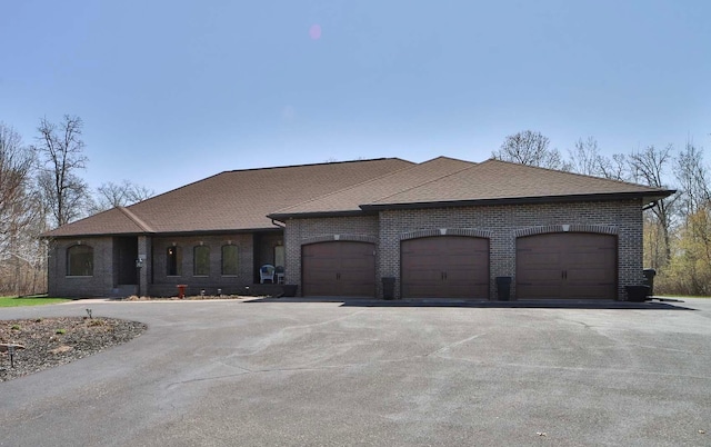 6203 Fairfax Ct, Baxter, MN 56425 - french country style house with brick siding, an attached garage, driveway, and roof with shingles